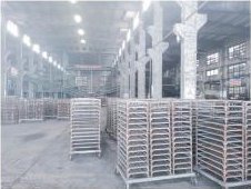Drying racks of finished charcoal in the production hall